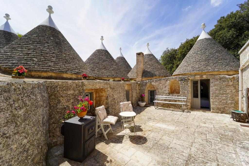 Stone trulli with conical roofs and courtyard at Villa Pesce
